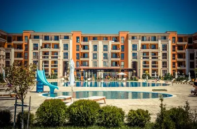 a large apartment building with a pool and a slide at Prestige Fort Beach - Menada Apartments in Sveti Vlas
