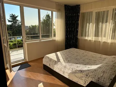 a bedroom with a bed and a large window at Apartment Sunny Seasons Byala in Byala