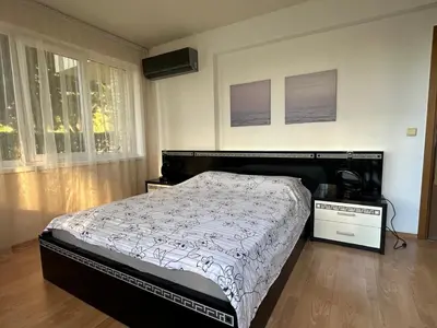 a bedroom with a large bed and a window at Apartment Sunny Seasons Byala in Byala