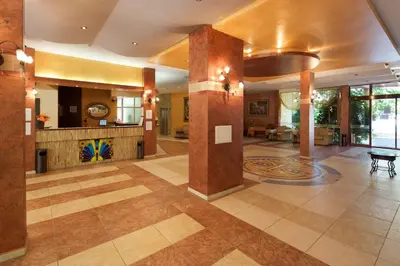 a large room with a lobby with a table at Yavor Palace Hotel - All Inclusive in Sunny Beach