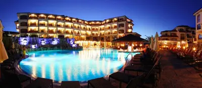 a large building with a swimming pool at night at Apartment Victoria Hotel & SPA Aheloy in Kableshkovo