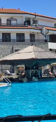 a large building with a large pool of blue water at Apartment Victoria Hotel & SPA Aheloy in Kableshkovo