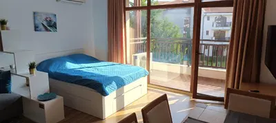 a bedroom with a bed and a large window at Apartment Victoria Hotel & SPA Aheloy in Kableshkovo