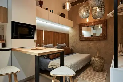 a bedroom with a bed with a desk and two chairs at Studio in the Center of Burgas next to the See in Burgas City