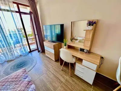 a bedroom with a desk and a large mirror at Apartament w Bułgarii in Sveti Vlas
