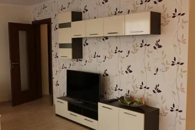 a living room with a flat screen tv on a wall at Vello Apartments in Byala