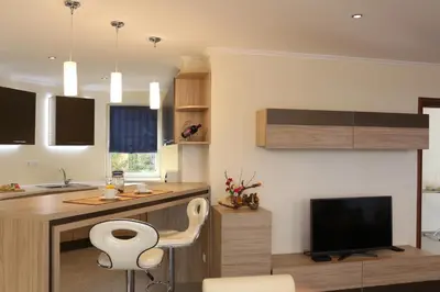 a kitchen with a desk and a tv in a room at Vello Apartments in Byala