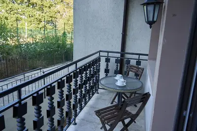 a table and chairs on a balcony with a window at The Cliff Lux Apartment Obzor, Burgas, Bulgaria in Obzor
