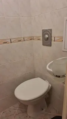 a bathroom with a toilet and a sink at Лазуро in Burgas City