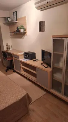 a bedroom with a desk with a computer on it at Лазуро in Burgas City