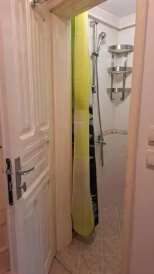 a bathroom with a shower with a yellow object at Лазуро in Burgas City