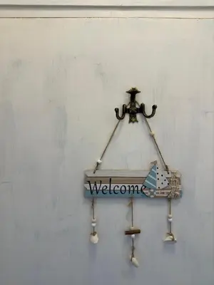 a welcome sign is hanging on a wall at Something In French in Burgas City