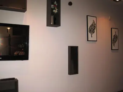 a white wall with pictures on it at Apartment Alegria in Varna City