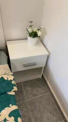 a white nightstand with a potted plant on it at Sunrise Sea Garden in Burgas City