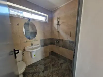 a bathroom with a sink and a toilet and a mirror at White Pearl Apartment Sozopol in Sozopol