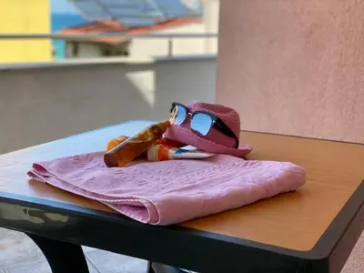a toy figure sitting on a napkin on a table at White Pearl Apartment Sozopol in Sozopol
