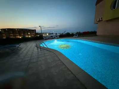 a swimming pool on a building with aperature at White Pearl Apartment Sozopol in Sozopol