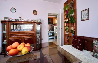 a kitchen with a bowl of fruit on a table at Apartment Dora in Pomorie
