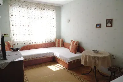 a room with a couch and a window with a table at Apartment Dora in Pomorie
