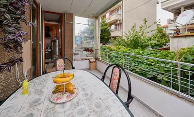 a table with bananas sitting on top of a balcony at Apartment Dora in Pomorie
