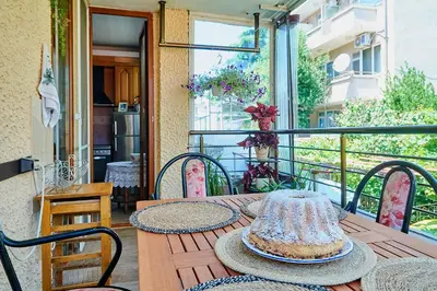 a table with a cake on top of a balcony at Apartment Dora in Pomorie