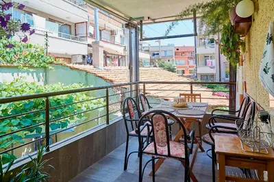 a patio with a table and chairs on a balcony at Apartment Dora in Pomorie
