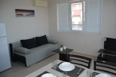 a living room with a couch and a table at Divela 3 Apartments in Nesebar