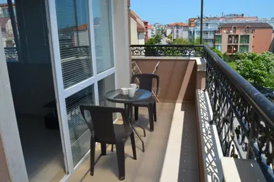 a balcony with two chairs and a table on it at Divela 3 Apartments in Nesebar