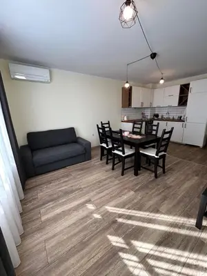 a living room with a table and chairs and a couch at Burgas in Burgas City