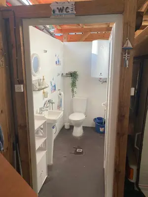 a bathroom with a toilet and a sink at Каравана Макси in Chernomorets