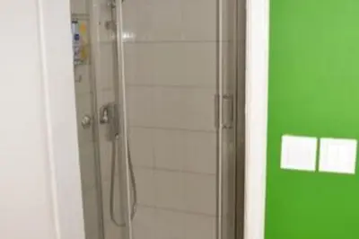 a shower with a glass door in a bathroom at Varna Heart Studio in Varna City