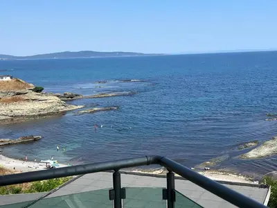 a view of a beach with people swimming in the water at Вила Арапя in Tsarevo