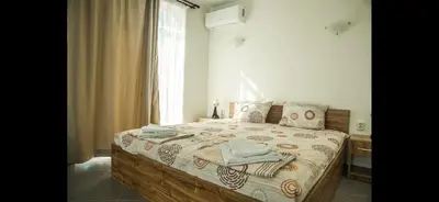 a bedroom with a bed with towels on it at Вила Арапя in Tsarevo