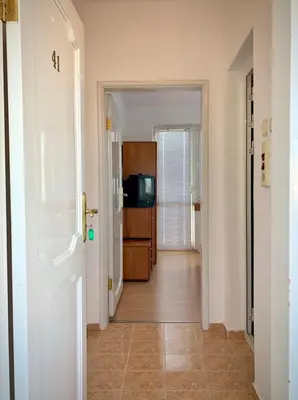 a hallway with a door leading to a kitchen at Тедис хоум in Burgas City