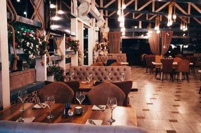 a restaurant with a table and chairs in a room at Apolonia Resort in Sozopol