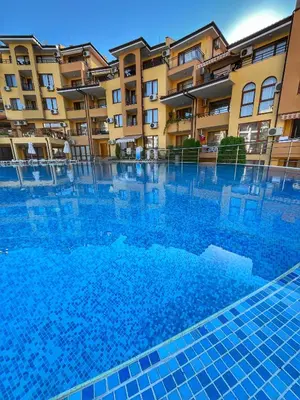 a swimming pool in front of a building at Paradise Dreams Studio in Sveti Vlas