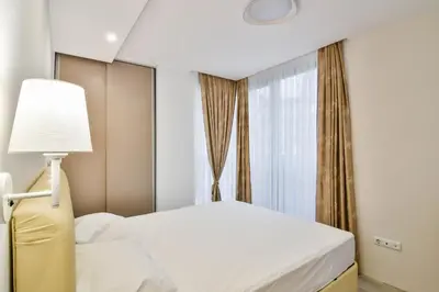 a bedroom with a bed and a window at Super central cozy flat in Varna City