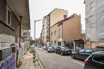 a city street with cars parked on the side at Super central cozy flat in Varna City