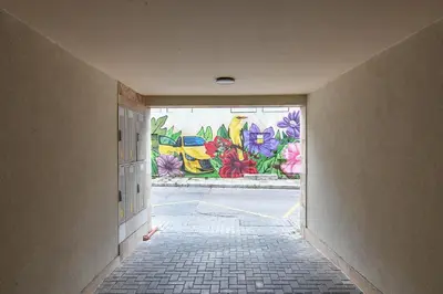 a hallway with a mural of flowers on a wall at Super central cozy flat in Varna City