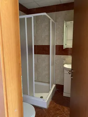 a bathroom with a shower with a toilet and a sink at Краун Форт in Sveti Vlas