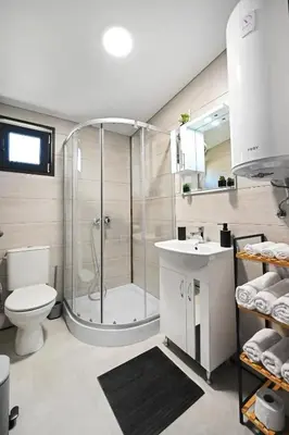 a bathroom with a shower and a toilet and a sink at Black Sea Villas Fichoza in Varna City
