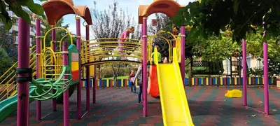 a playground with a yellow and colorful slide at Apartament Amelia in Sunny Beach
