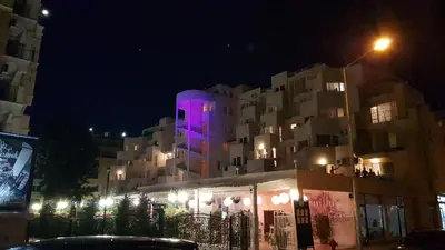 a building with a purple light on it at night at Vanilla Garden Apartments in Sunny Beach