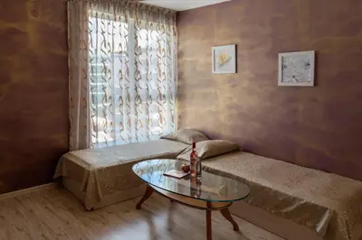 a small room with a bed and a glass table at Vanilla Garden Apartments in Sunny Beach