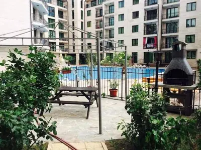 a patio with a grill and a picnic table in front of a building at Best Location in Sunny Beach Amber Beach in Sunny Beach