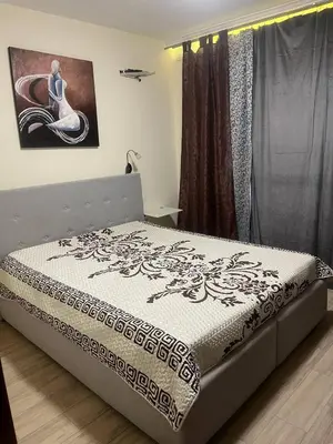a bed in a bedroom with a picture on the wall at Cascadas in Ravda