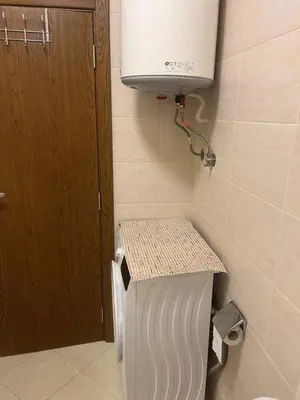 a small bathroom with a toilet and a water tank at Cascadas in Ravda