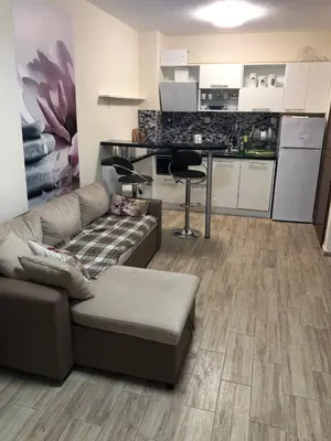 a living room with a couch and a kitchen at Cascadas in Ravda