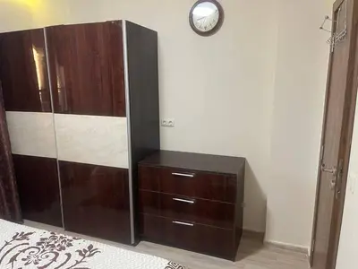 a large wooden cabinet with a clock on a wall at Cascadas in Ravda