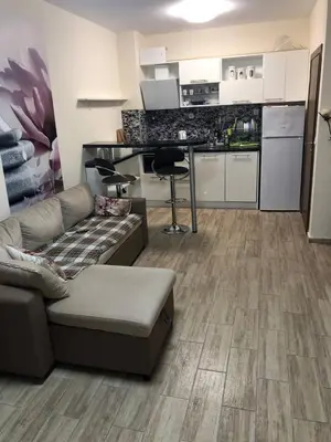 a living room with a couch and a kitchen at Cascadas in Ravda
